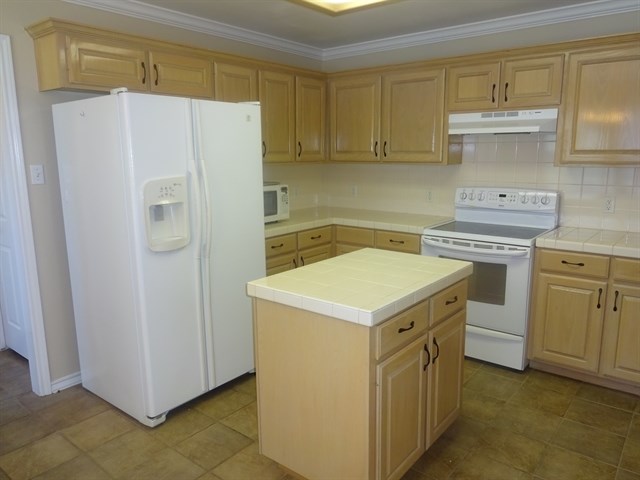Undisclosed Address Corpus Christi, TX 78413 - Photo 5 of 15 a kitchen with a stove a refrigerator and a sink