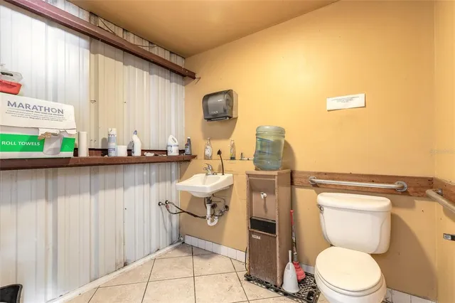 a bathroom with a toilet a sink and a window