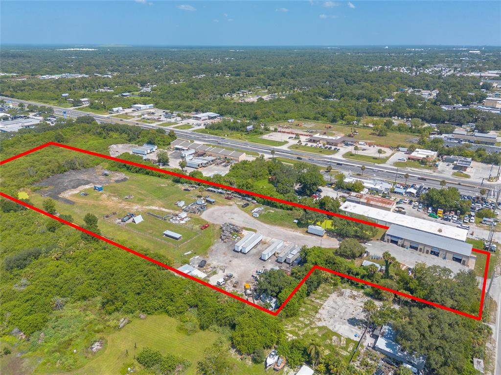 135 Clearlake Road Cocoa, FL 32926 - Photo 16 of 22 an aerial view of residential houses with outdoor space and trees