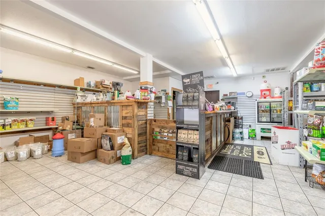 a room with lots of white furniture and a chandelier