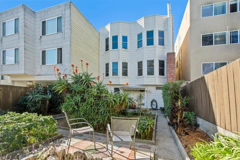 a view of multiple house with backyard and patio