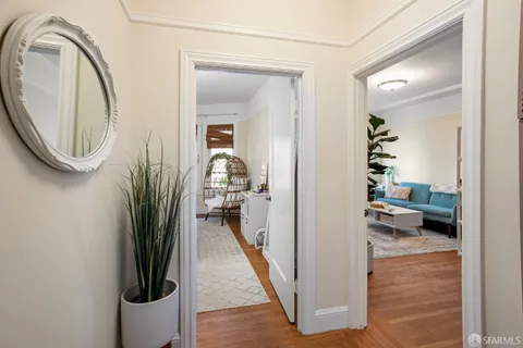 a view of a hallway and a livingroom with furniture