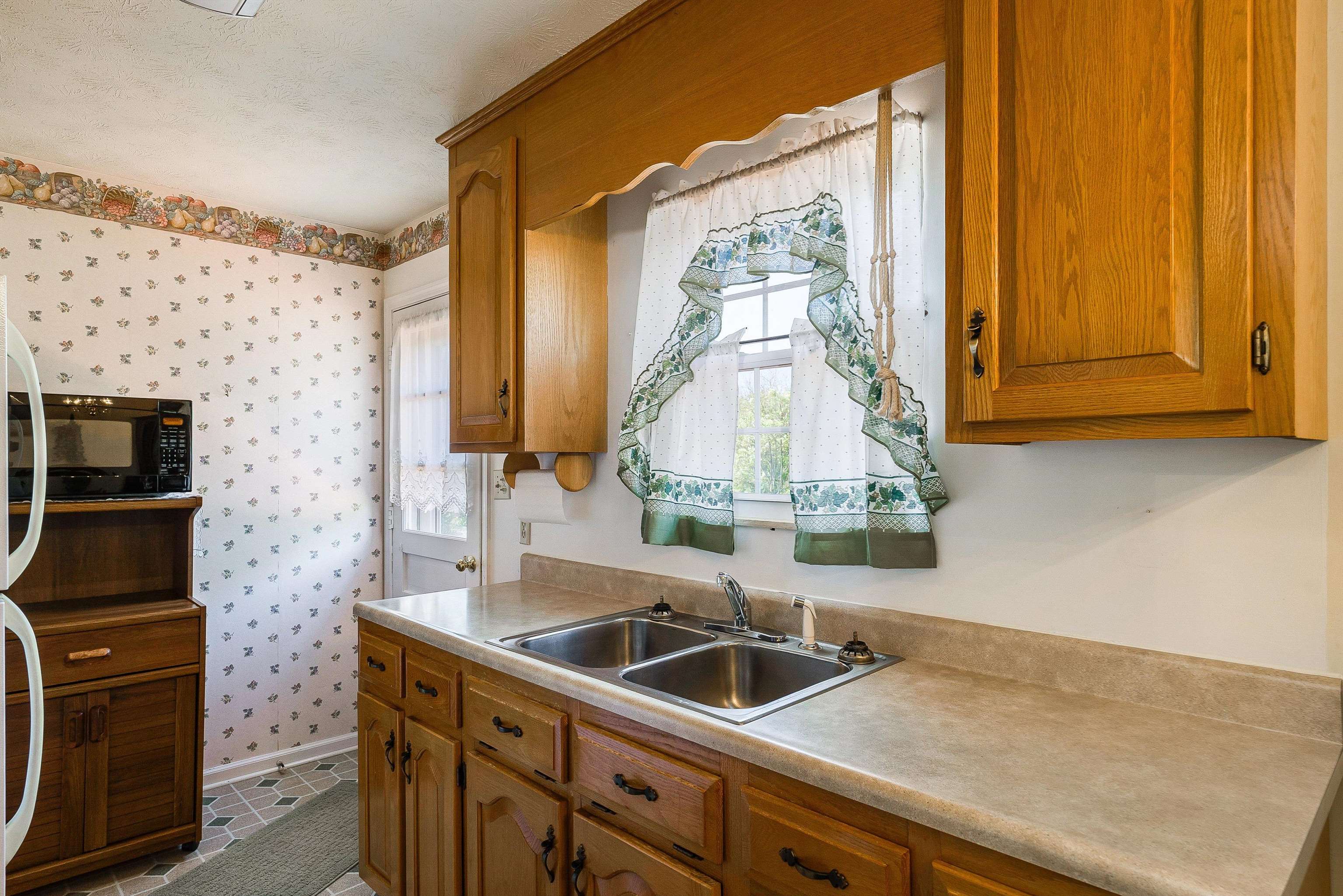 3430 Oak Ridge Road Mount Crawford, VA 22841 - Photo 15 of 59 a kitchen with a sink and a microwave