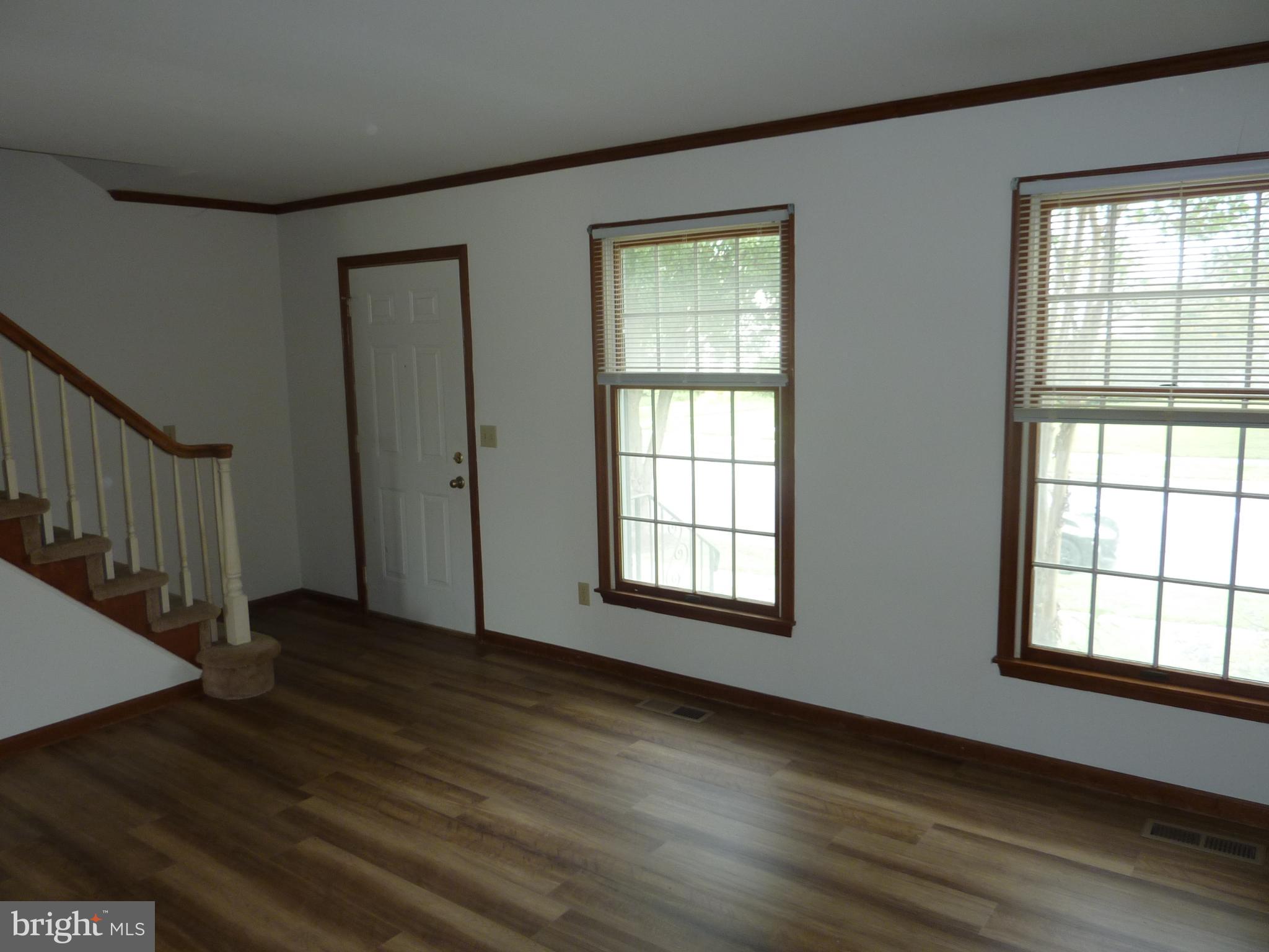 1008 Sumac Circle Salisbury, MD 21804 - Photo 4 of 21 a view of an empty room with wooden floor and a window