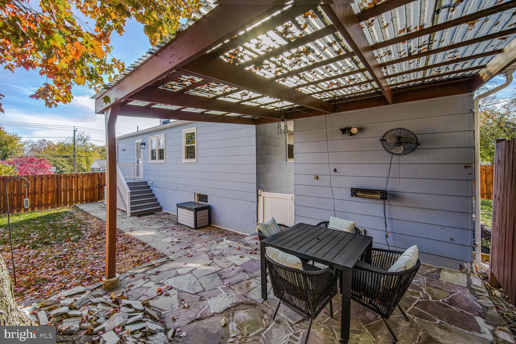 807 Lanark Way Silver Spring, MD 20901 - Photo 25 of 39 a backyard of a house with barbeque oven table and chairs