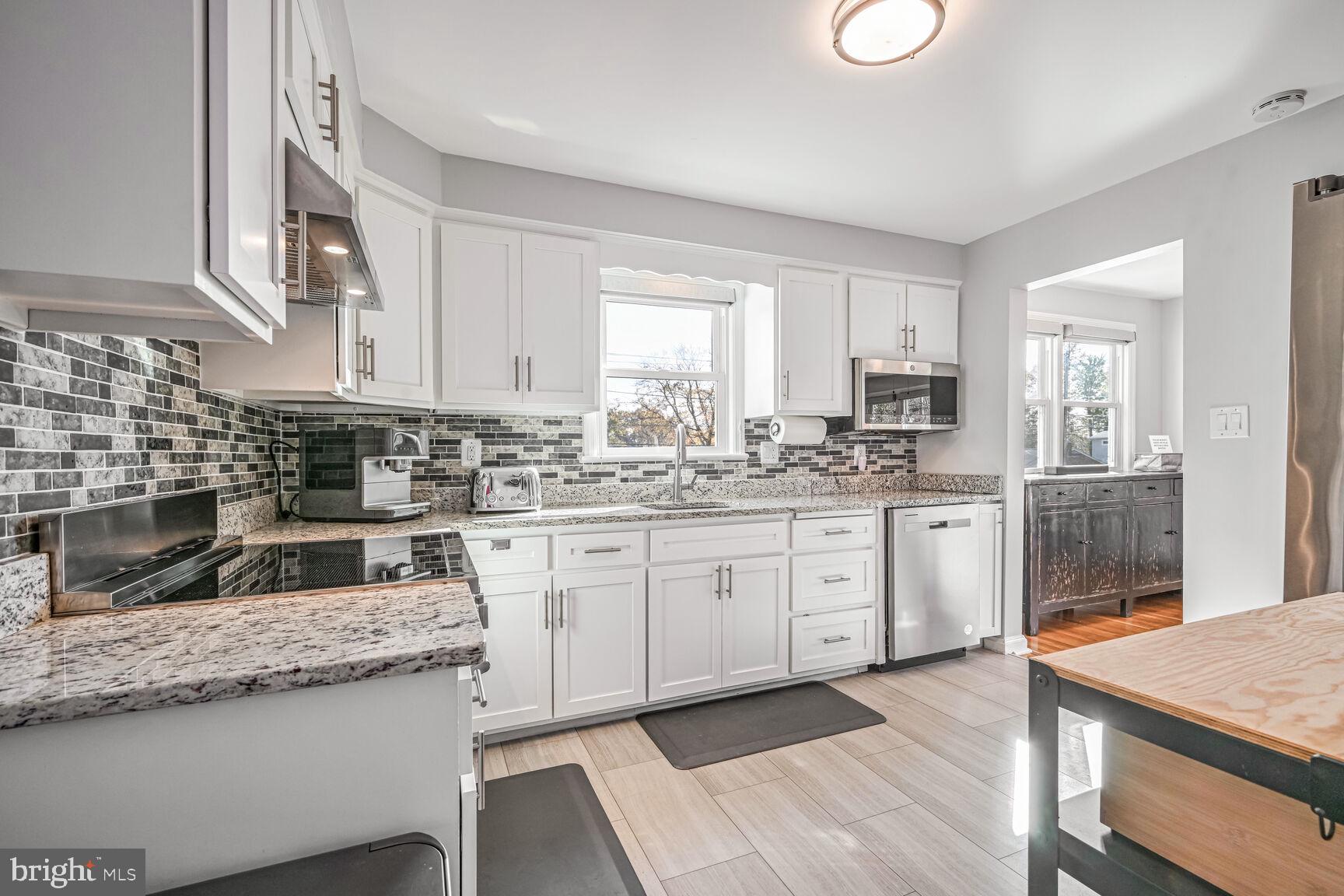 807 Lanark Way Silver Spring, MD 20901 - Photo 6 of 39 a kitchen with granite countertop cabinets stainless steel appliances a sink and a window