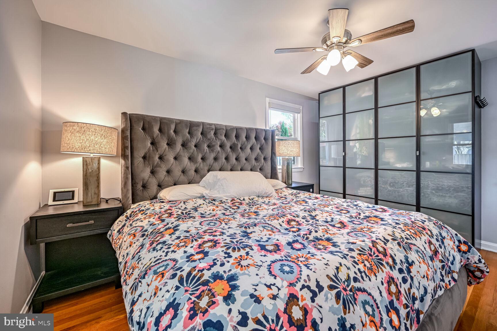 807 Lanark Way Silver Spring, MD 20901 - Photo 9 of 39 a bedroom with a bed and a chandelier