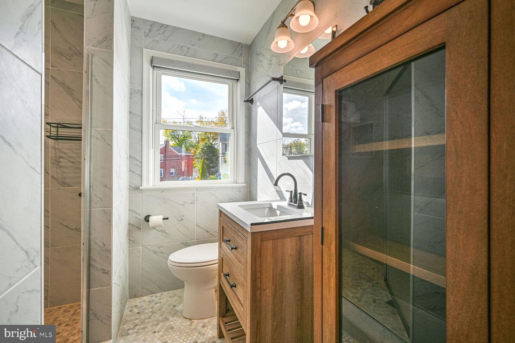 807 Lanark Way Silver Spring, MD 20901 - Photo 10 of 39 a bathroom with a toilet a sink and a window