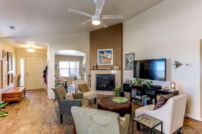 4068 Desert Ridge Circle Castle Rock, CO 80108 - Photo 6 of 25 a living room with fireplace furniture and a flat screen tv