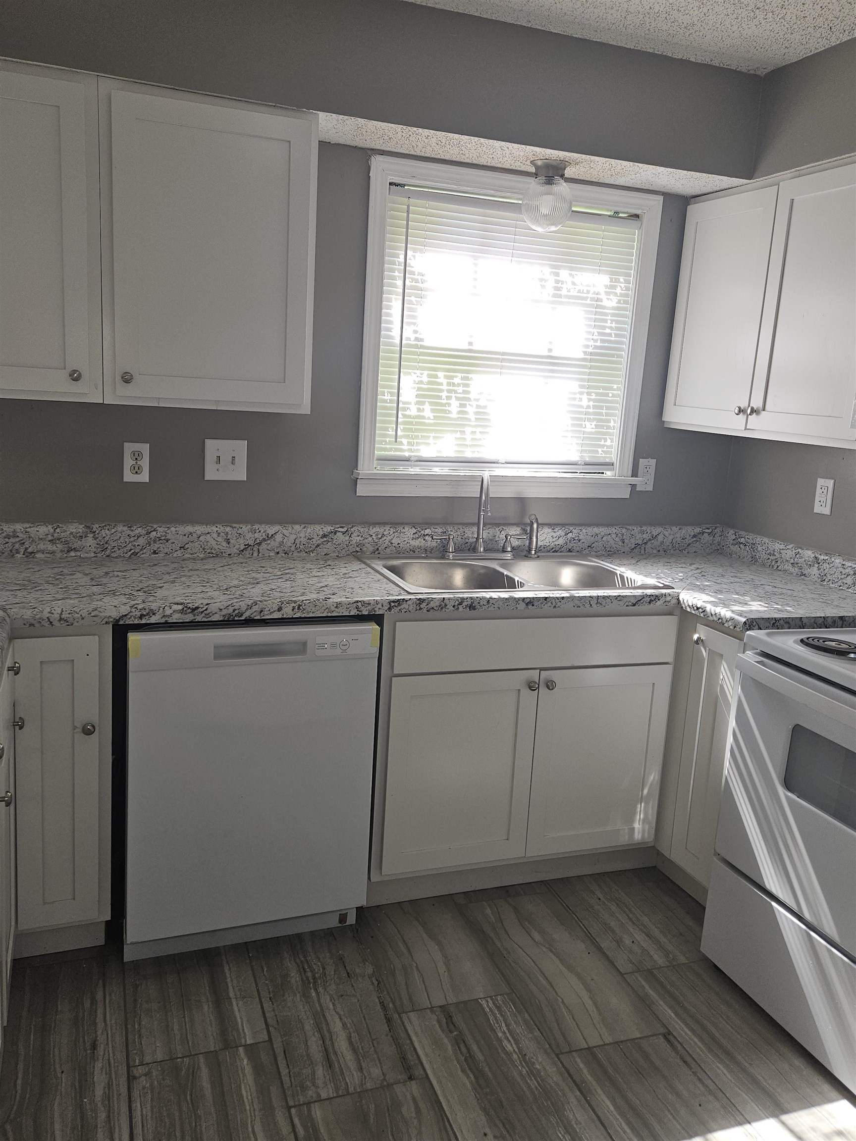 6223 Ashton Road, Unit 6223A Memphis, TN 38134 - Photo 3 of 14 a kitchen with granite countertop white cabinets white appliances and a window