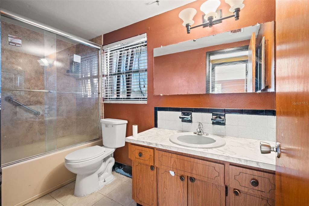 11200 Tamarix Avenue Port Richey, FL 34668 - Photo 12 of 28 a bathroom with a sink toilet and shower