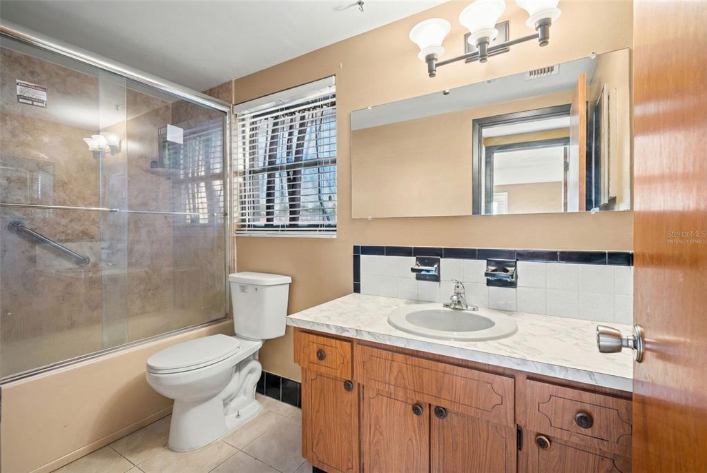 11200 Tamarix Avenue Port Richey, FL 34668 - Photo 21 of 28 a bathroom with a sink toilet and shower