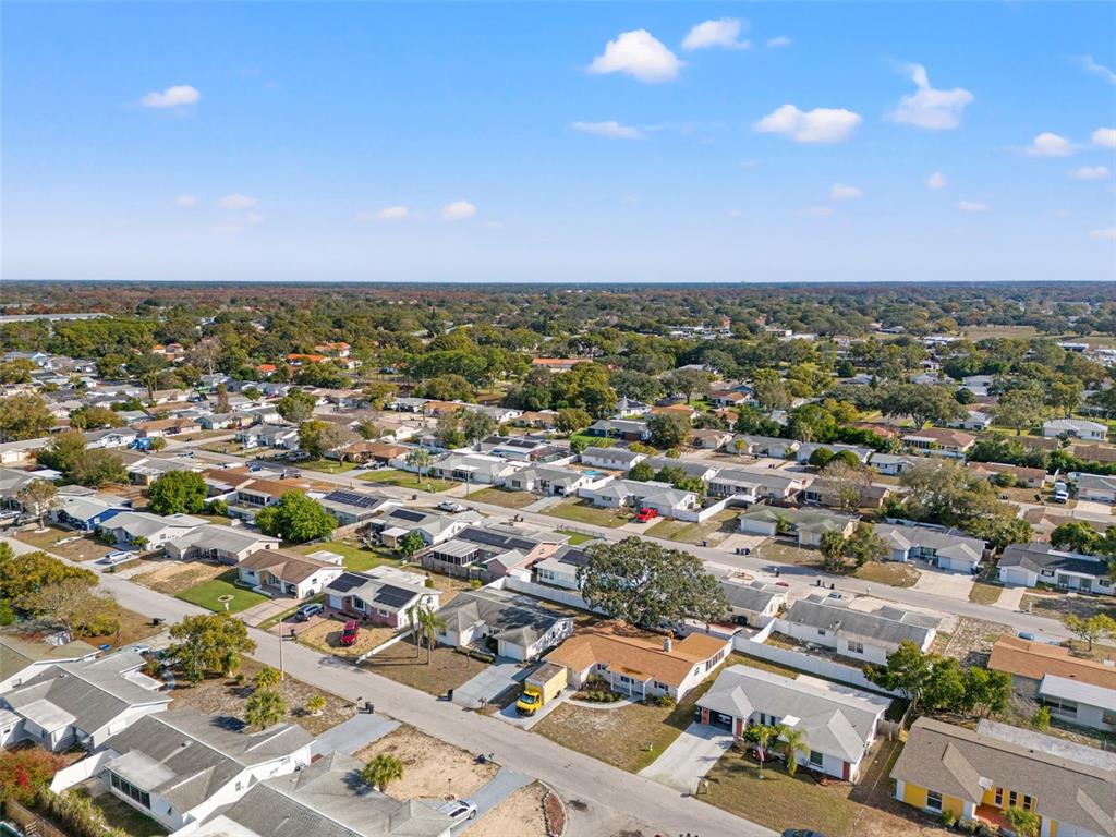 11200 Tamarix Avenue Port Richey, FL 34668 - Photo 28 of 28 an aerial view of a city with lots of residential buildings and mountain view in back