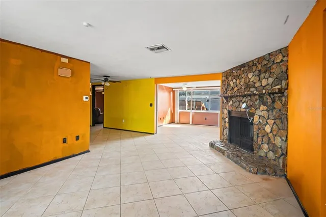a view of a livingroom with a fireplace and window