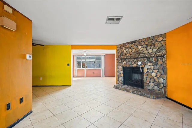 a view of empty room with a fireplace