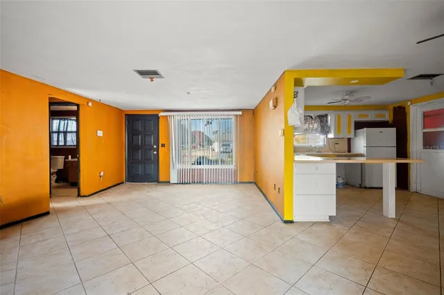 a view of a kitchen with a sink and a refrigerator