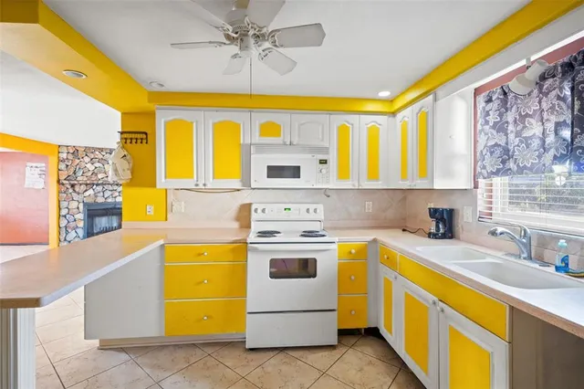 a kitchen with a sink stove and refrigerator