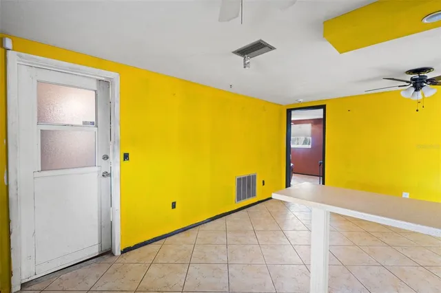 a view of a livingroom with a fireplace and a chandelier