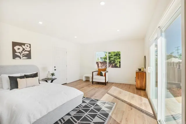 a bedroom with a bed and wooden floor