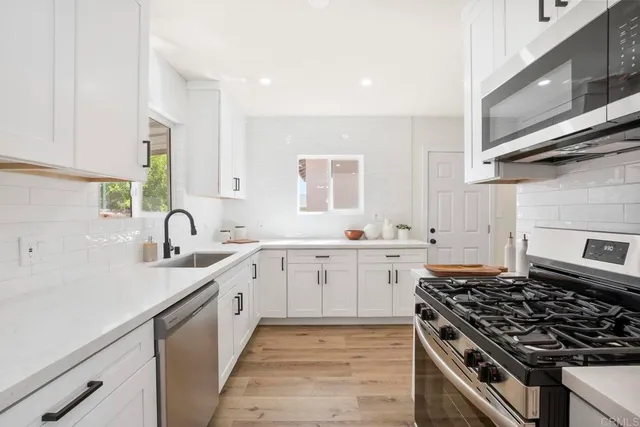 a kitchen with a sink stove and cabinets