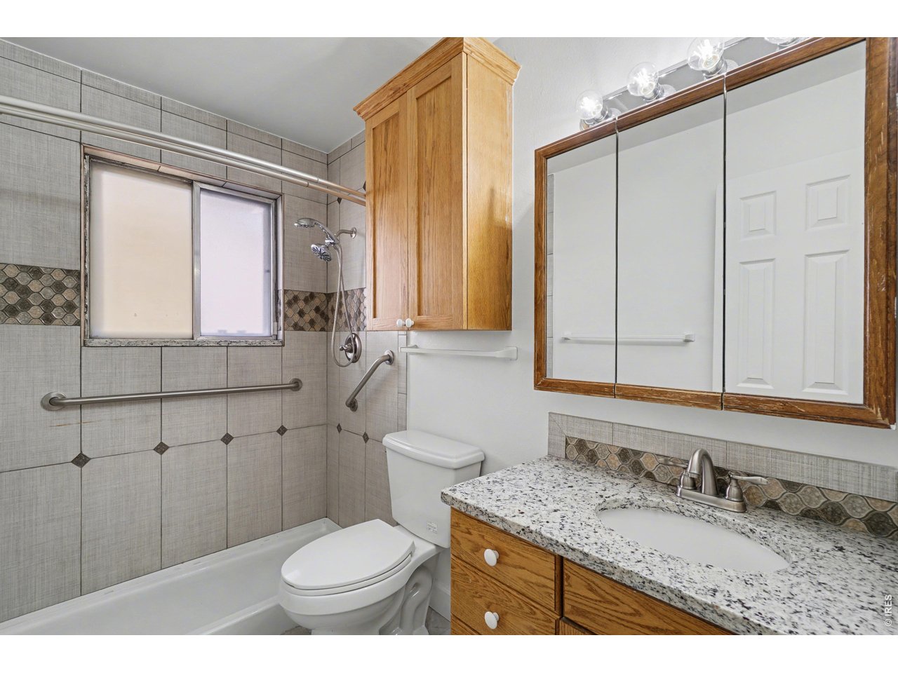 3711 West 7th Street Road Greeley, CO 80634 - Photo 19 of 39 Shared hall bath has updated tile and granite vanity top