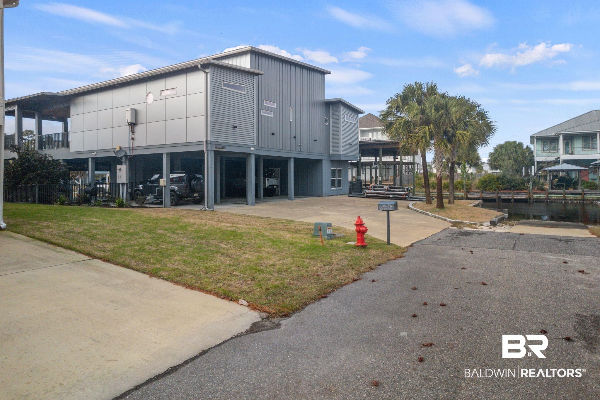 3840 Cotton Way Orange Beach, AL 36561 - Photo 74 of 75 View of building exterior with a carport