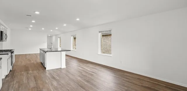 a view of kitchen with furniture and wooden floor