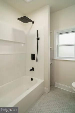 a bathroom with a bathtub and a shower