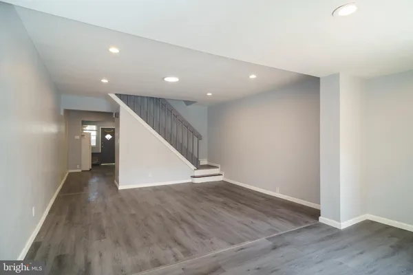 a view of a hallway with wooden floor