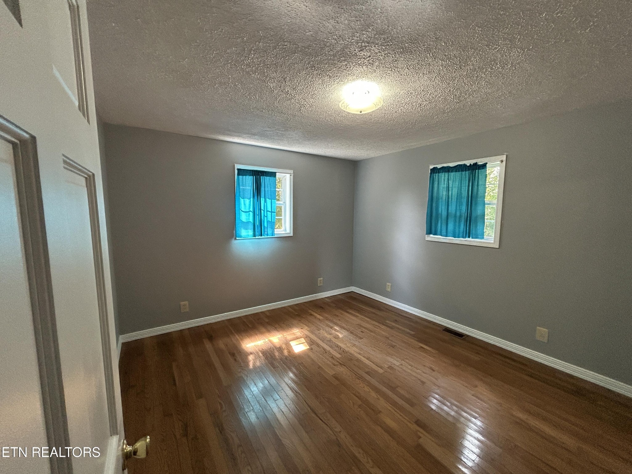 2702 Baseline Road Jamestown, TN 38556 - Photo 20 of 22 a view of empty room with wooden floor and fan