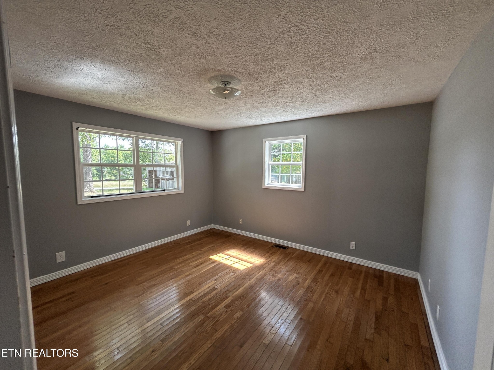 2702 Baseline Road Jamestown, TN 38556 - Photo 21 of 22 a view of an empty room with wooden floor and a window