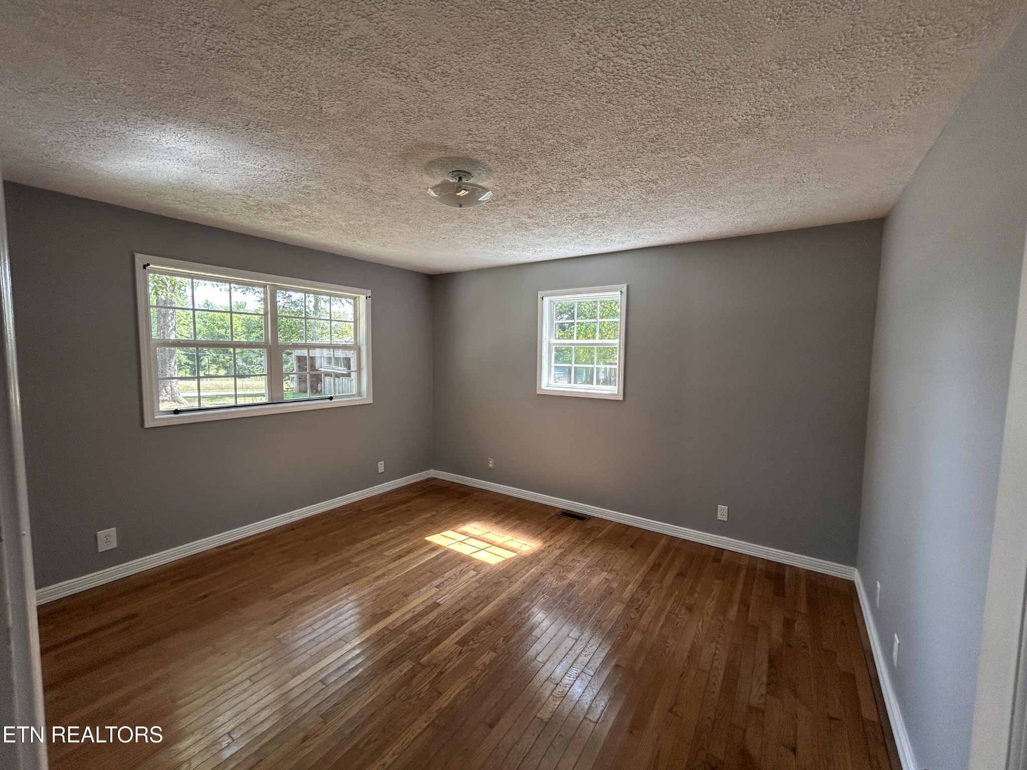 2702 Baseline Road Jamestown, TN 38556 - Photo 22 of 22 a view of an empty room with wooden floor and a window