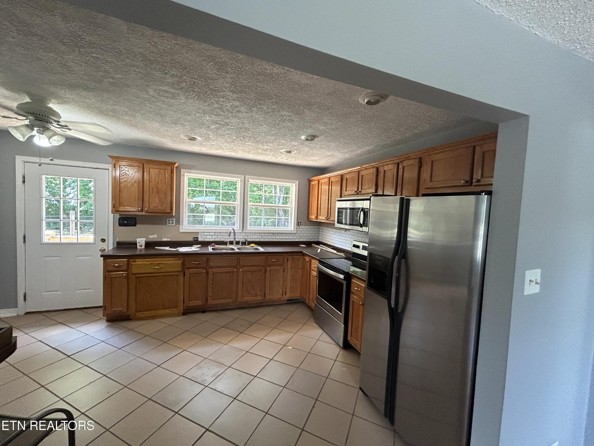 2702 Baseline Road Jamestown, TN 38556 - Photo 8 of 22 a kitchen with stainless steel appliances granite countertop a refrigerator and a sink