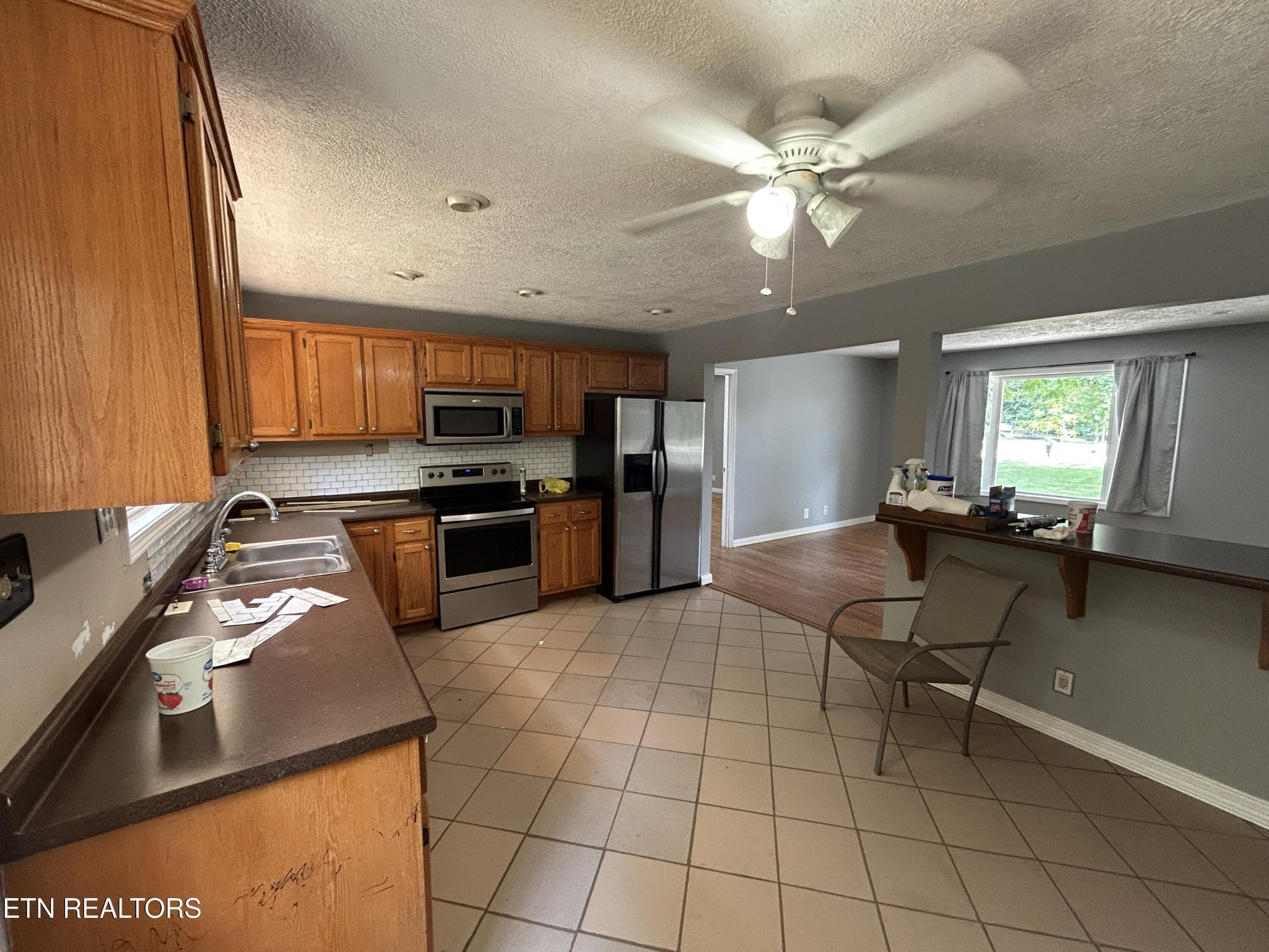 2702 Baseline Road Jamestown, TN 38556 - Photo 9 of 22 a kitchen with a sink a counter top space appliances and cabinets