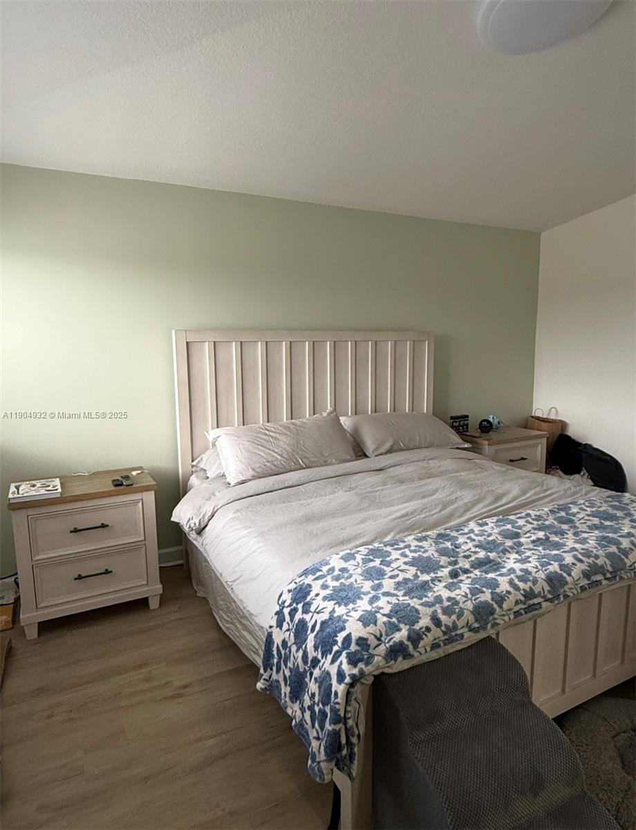481 Northeast 194th Terrace, Unit 481 Miami, FL 33179 - Photo 11 of 23 a bed sitting in a bedroom next to a window