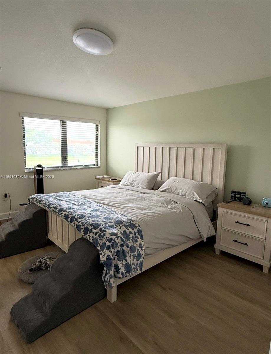 481 Northeast 194th Terrace, Unit 481 Miami, FL 33179 - Photo 12 of 23 a bedroom with a bed and a dresser