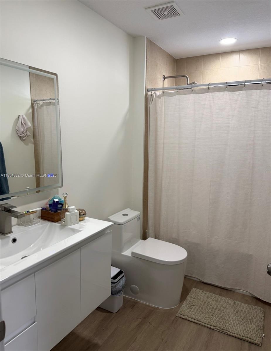 481 Northeast 194th Terrace, Unit 481 Miami, FL 33179 - Photo 17 of 23 a bathroom with a sink a toilet and shower