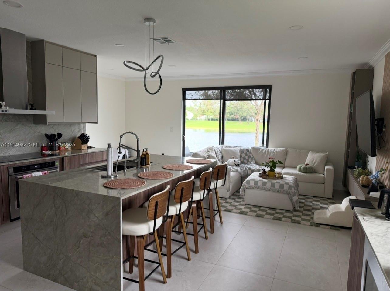 481 Northeast 194th Terrace, Unit 481 Miami, FL 33179 - Photo 2 of 23 a view of a dining room with furniture window and outside view