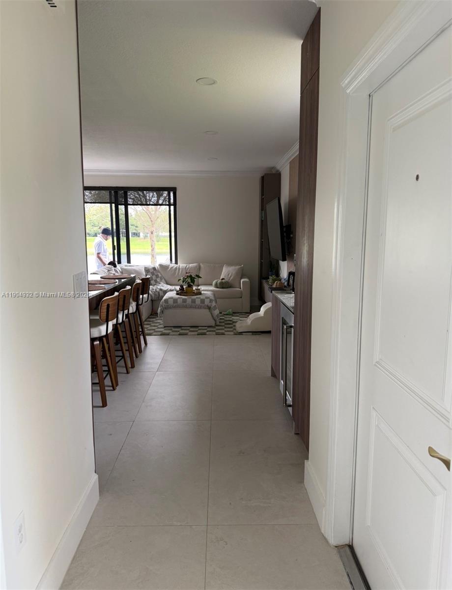 481 Northeast 194th Terrace, Unit 481 Miami, FL 33179 - Photo 3 of 23 a living room with lots of furniture and a window