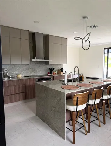a kitchen with a sink cabinets and window
