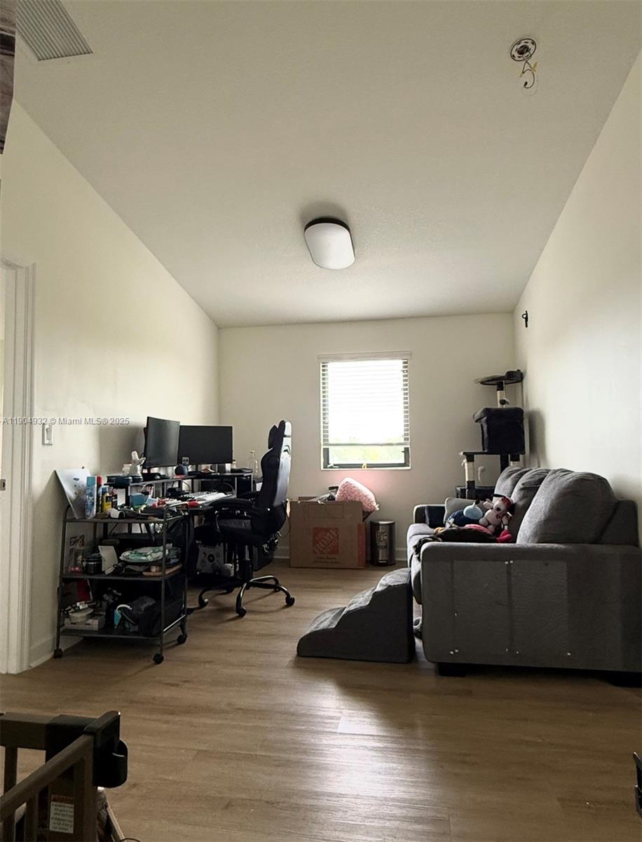 481 Northeast 194th Terrace, Unit 481 Miami, FL 33179 - Photo 10 of 23 a living room with furniture and a wooden floor