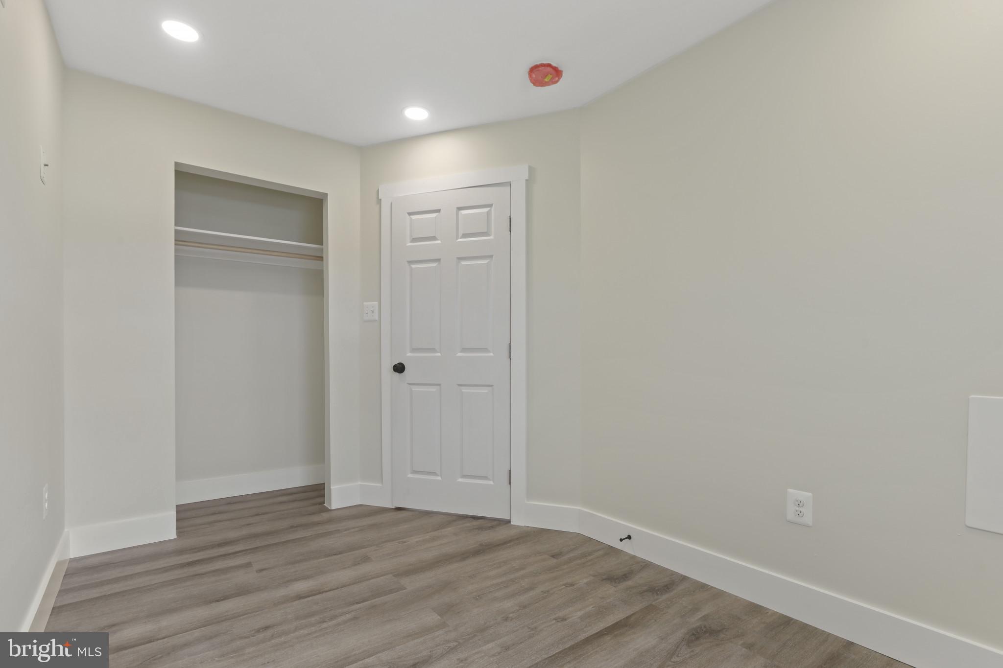 3828 10th Street Baltimore, MD 21225 - Photo 18 of 27 a view of an empty room with wooden floor