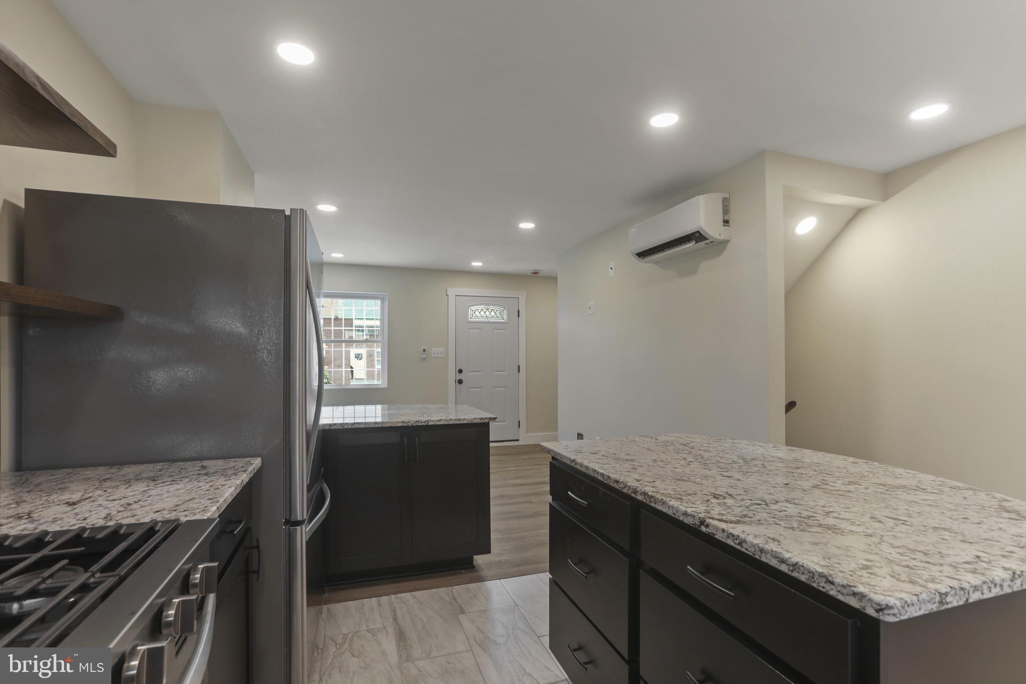 3828 10th Street Baltimore, MD 21225 - Photo 10 of 27 a kitchen with granite countertop a sink and stove