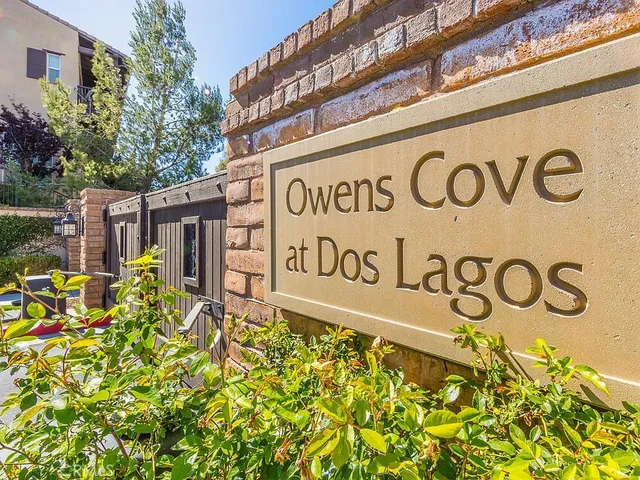 a view of a swimming pool with lawn chairs under an umbrella