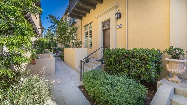 aerial view of a house with a yard and potted plants