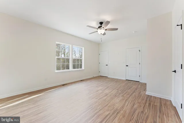 a white toilet sitting next to a bathroom shower