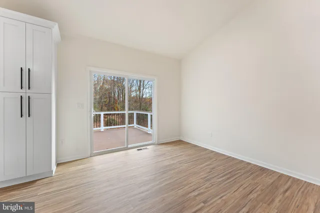 a view of kitchen with kitchen island sink and living room view
