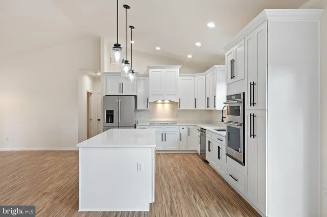 a kitchen with a sink stove and refrigerator