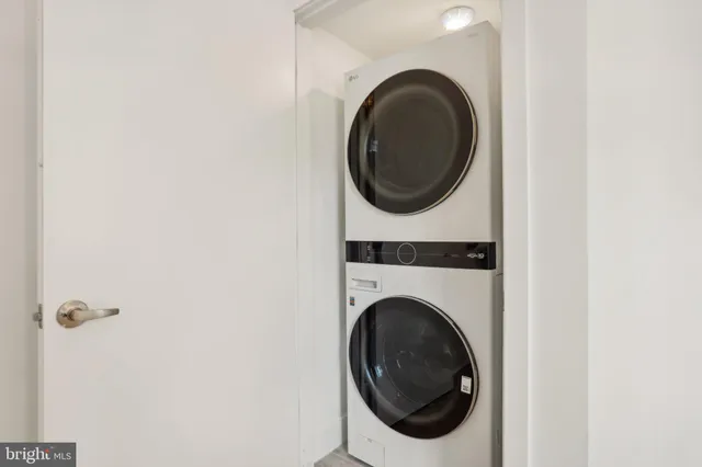 a close up view of a washer and dryer in a small bathroom