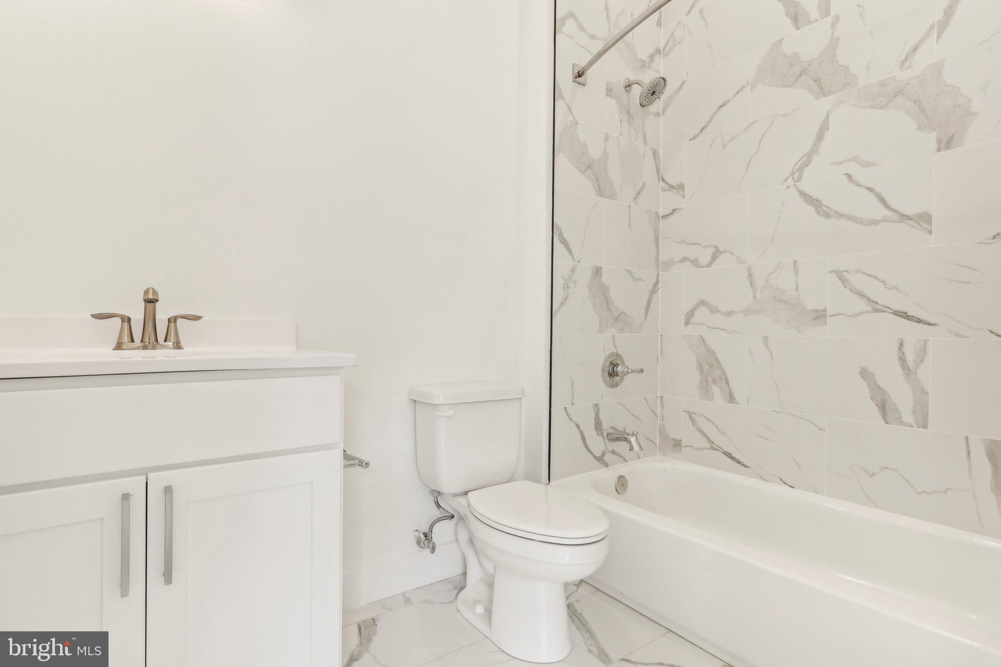 3952 Lancaster Avenue, Unit 101 Philadelphia, PA 19104 - Photo 6 of 6 a bathroom with a toilet and a bathtub